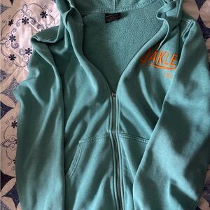 Oakley Teal Hoodie Jacket with Orange Logo